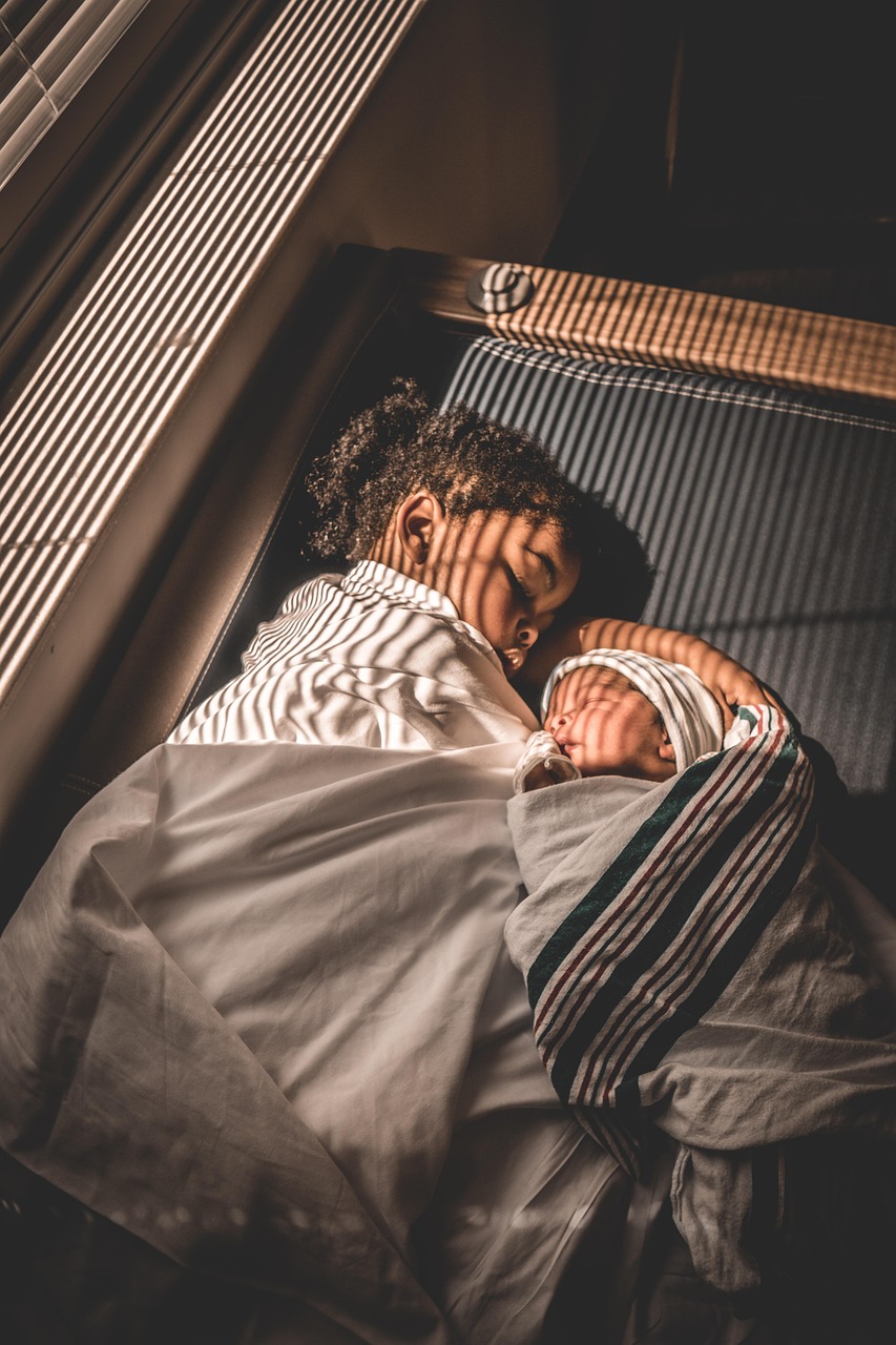 : Two boys peacefully sleeping together under a blanket